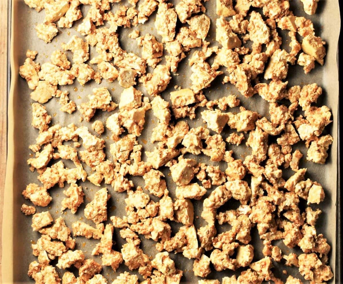 Crumbled tofu on baking sheet.