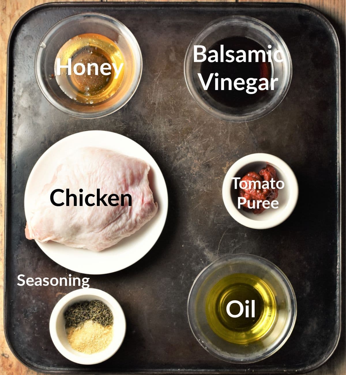 Ingredients for sheet pan chicken thighs in individual dishes.