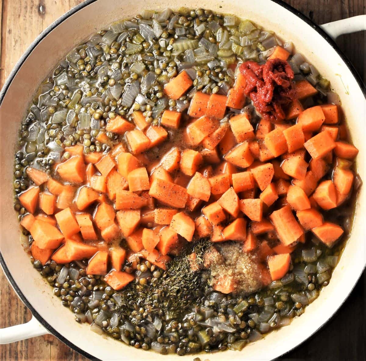 Cooking puy lentils and cubed carrots.