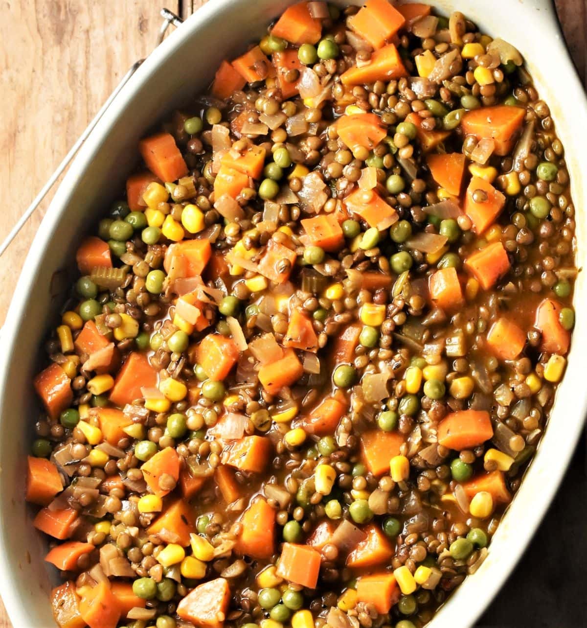 Lentil and vegetable pie filling in oval dish.