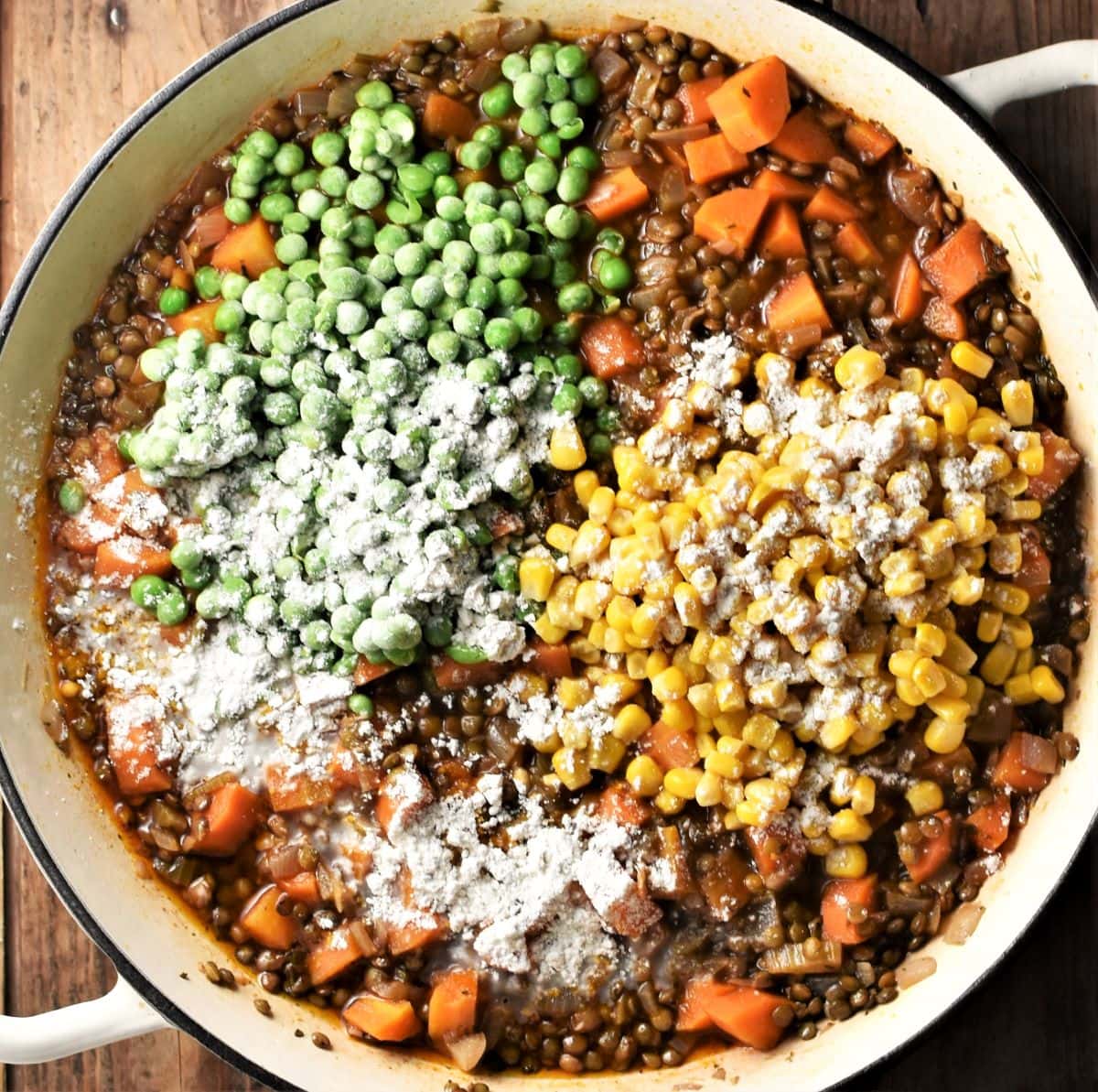 Cooking lentil shepherd's pie filling with vegetables and flour visible.
