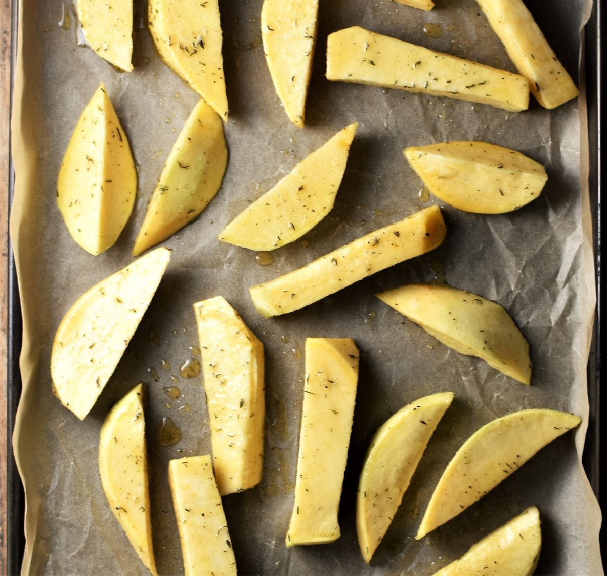 Rutabaga wedges on top of parchment.