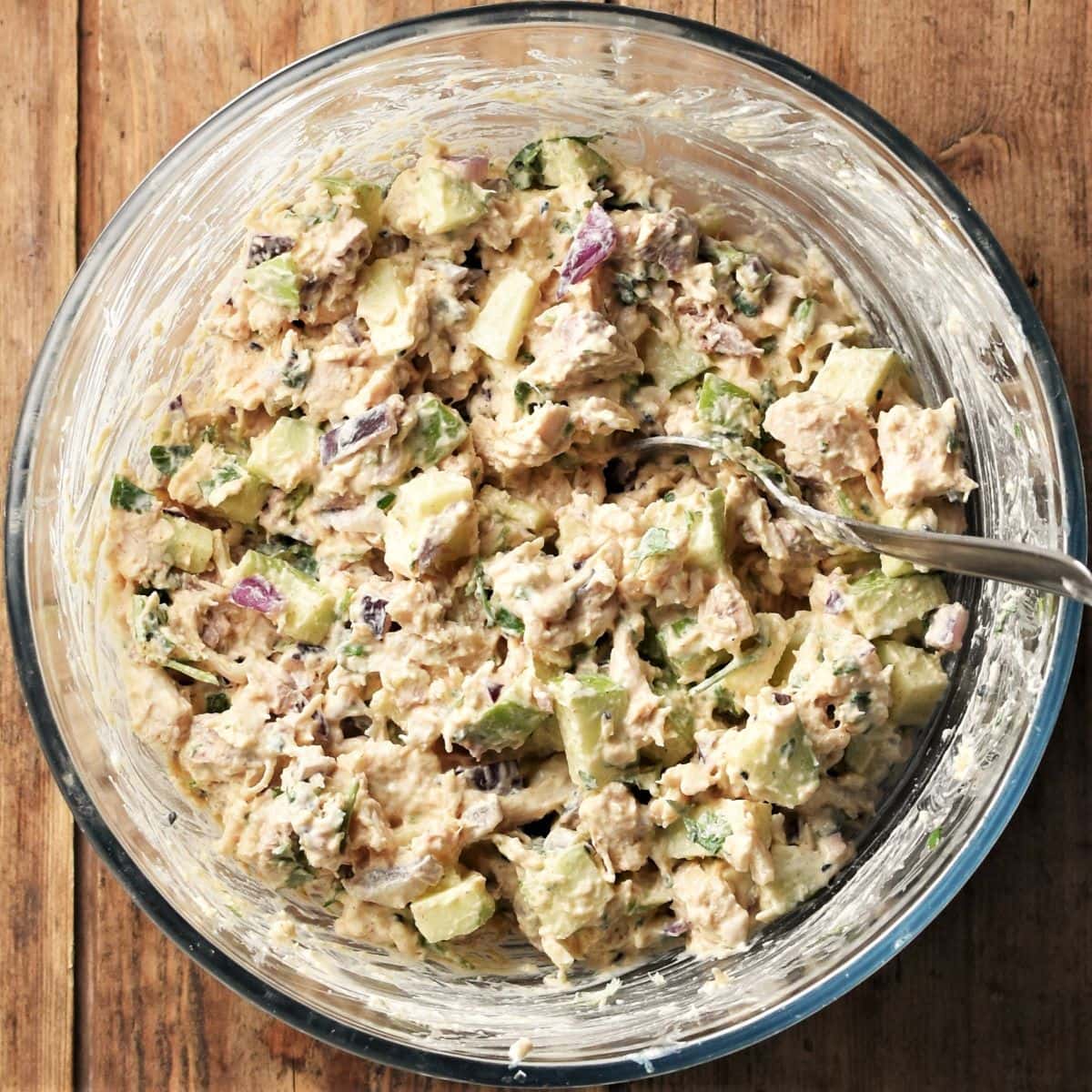 Turkey salad sandwich mixture in bowl with spoon.