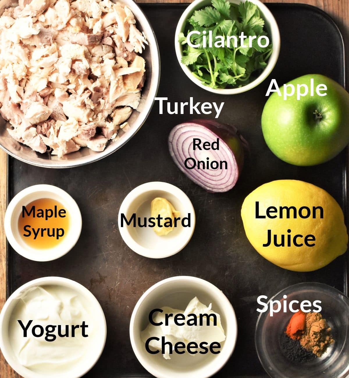 Ingredients for turkey salad sandwich in individual dishes.