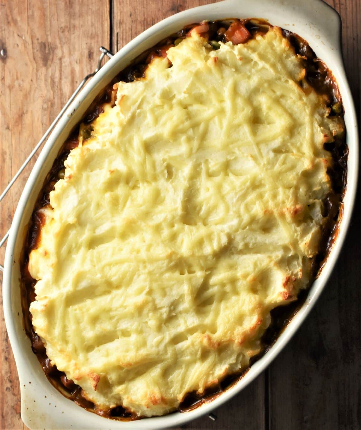 Top down view of baked vegetarian shepherd's pie in oval dish.