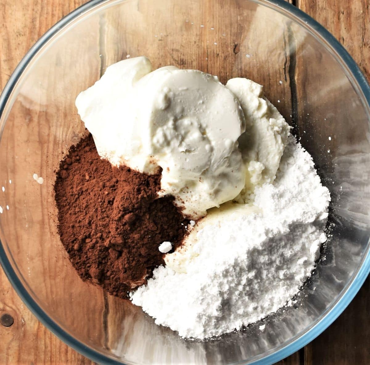 Yogurt, cocoa and icing sugar in mixing bowl.