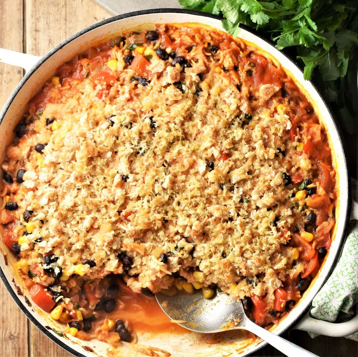 Turkey and rice casserole in large shallow pan with spoon.