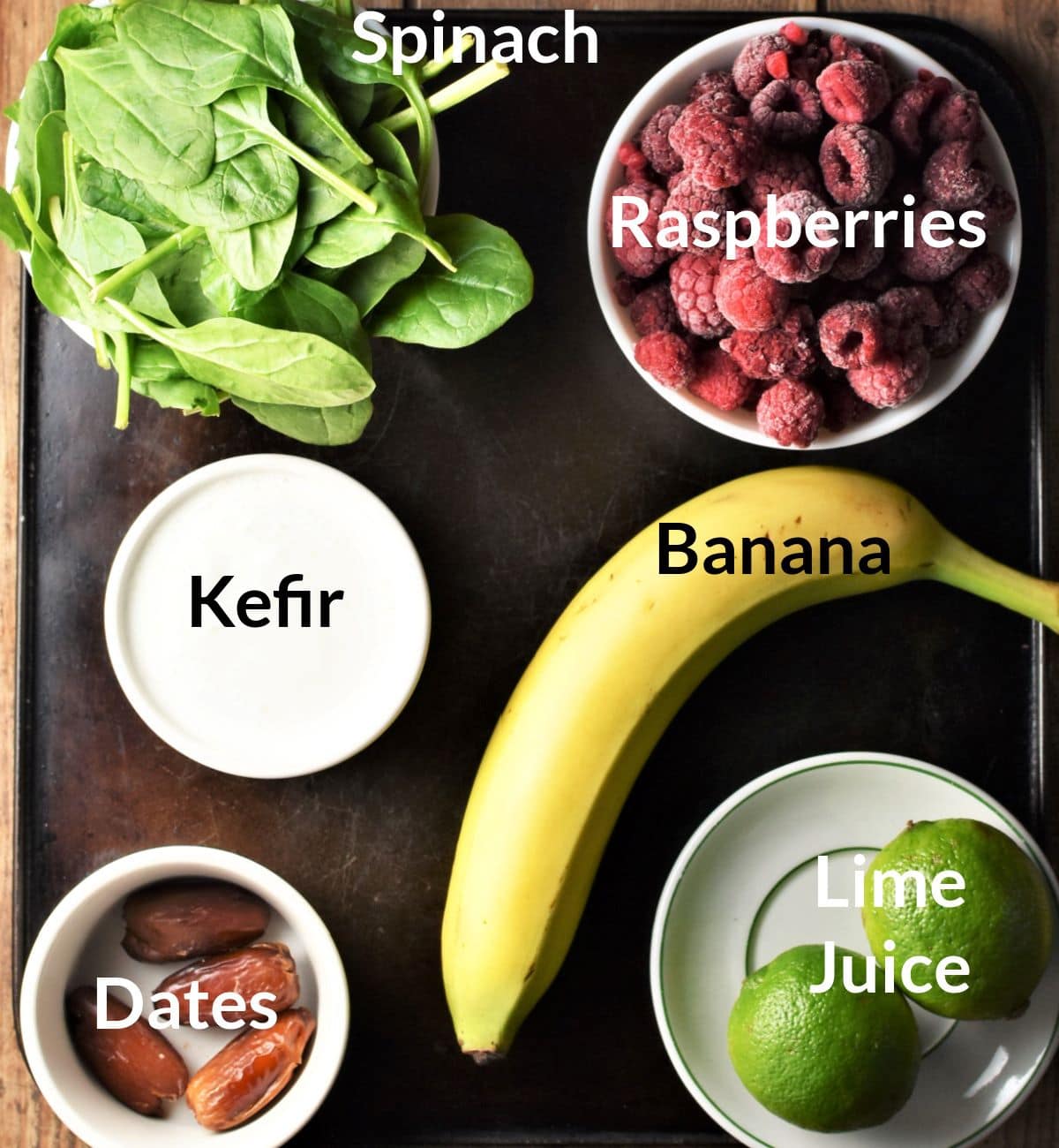 Ingredients for making spinach and raspberry smoothie in individual dishes.