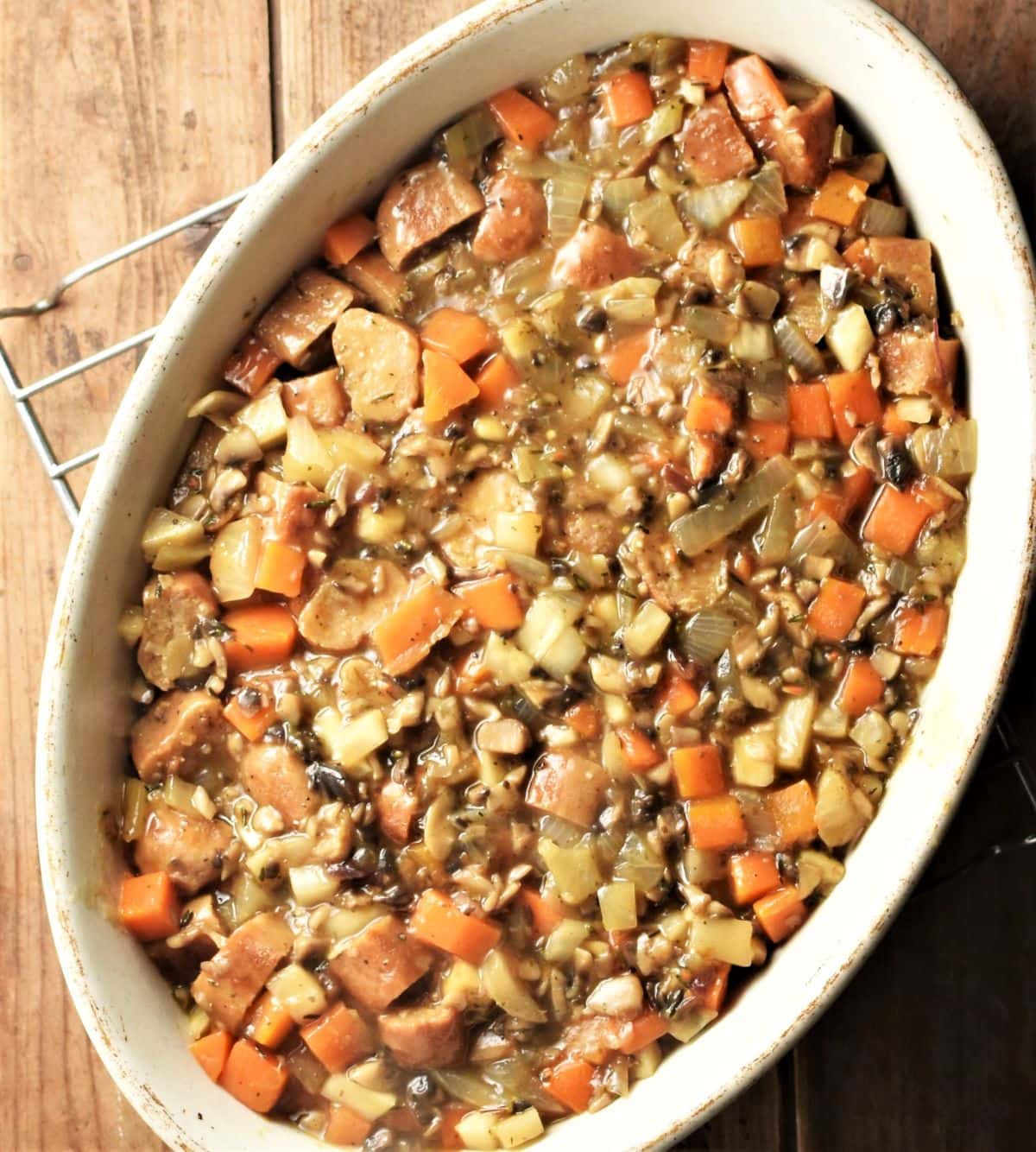 Sausage pie filling mixture inside oval dish.