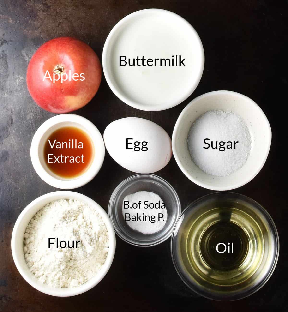 Ingredients for Polish apple pancakes close together in small dishes.