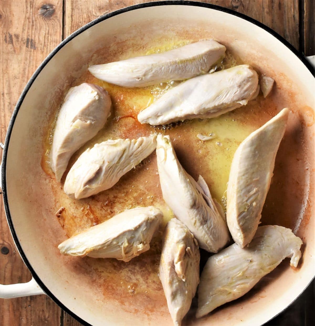 Frying strips of chicken breast in large shallow pan.