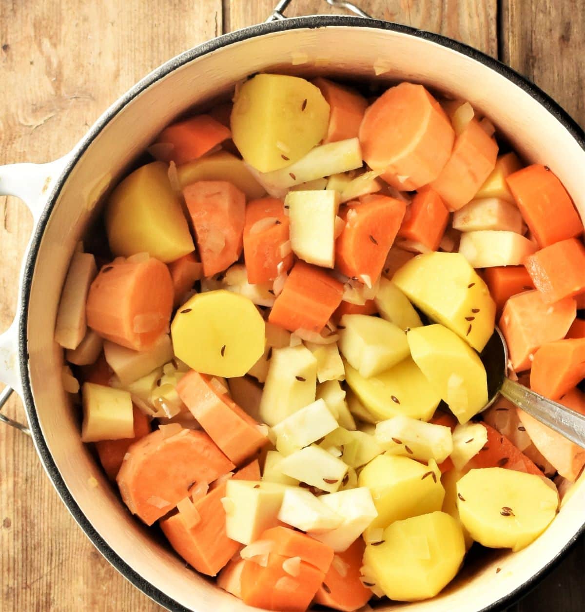Chopped peeled root vegetables in large pot.