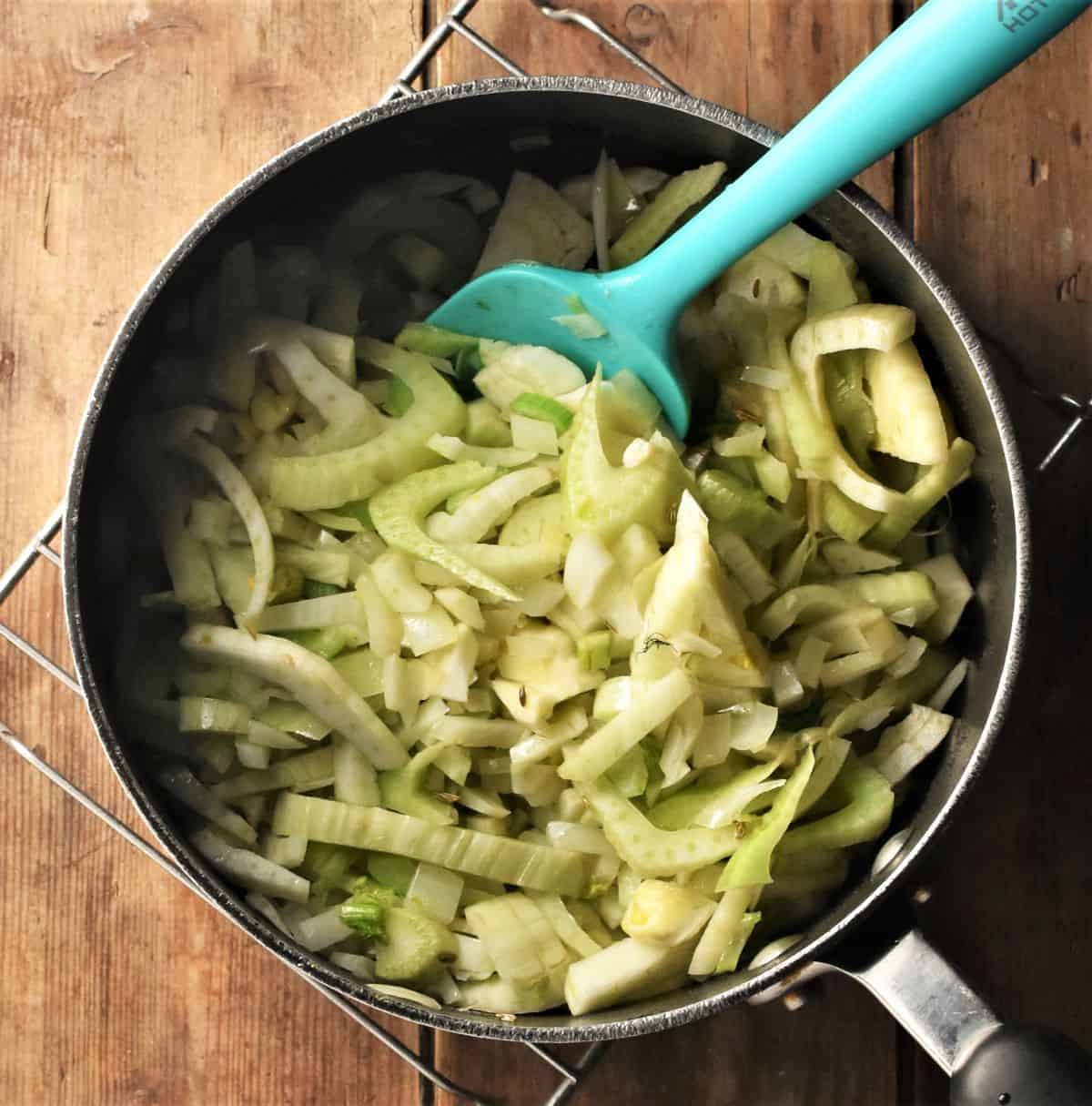 Cooking chopped fennel for soup in large pot.
