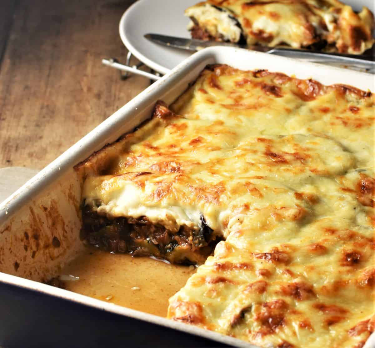 Close-up side view of mushroom moussaka in casserole dish.