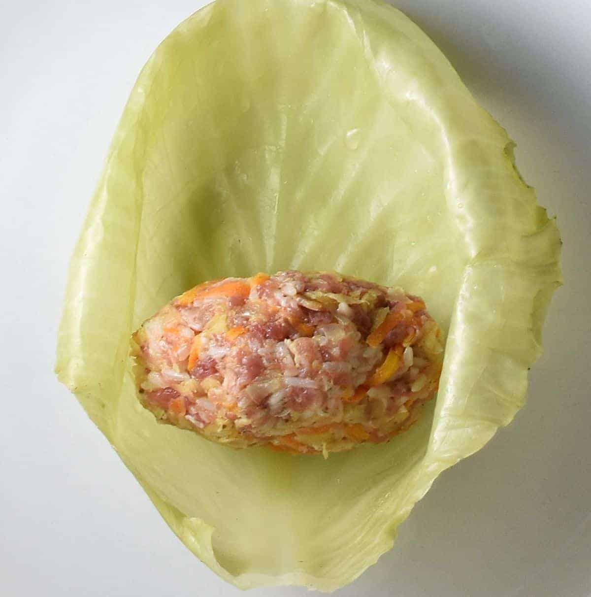 Round sauerkraut cabbage roll filling in cabbage leaf.