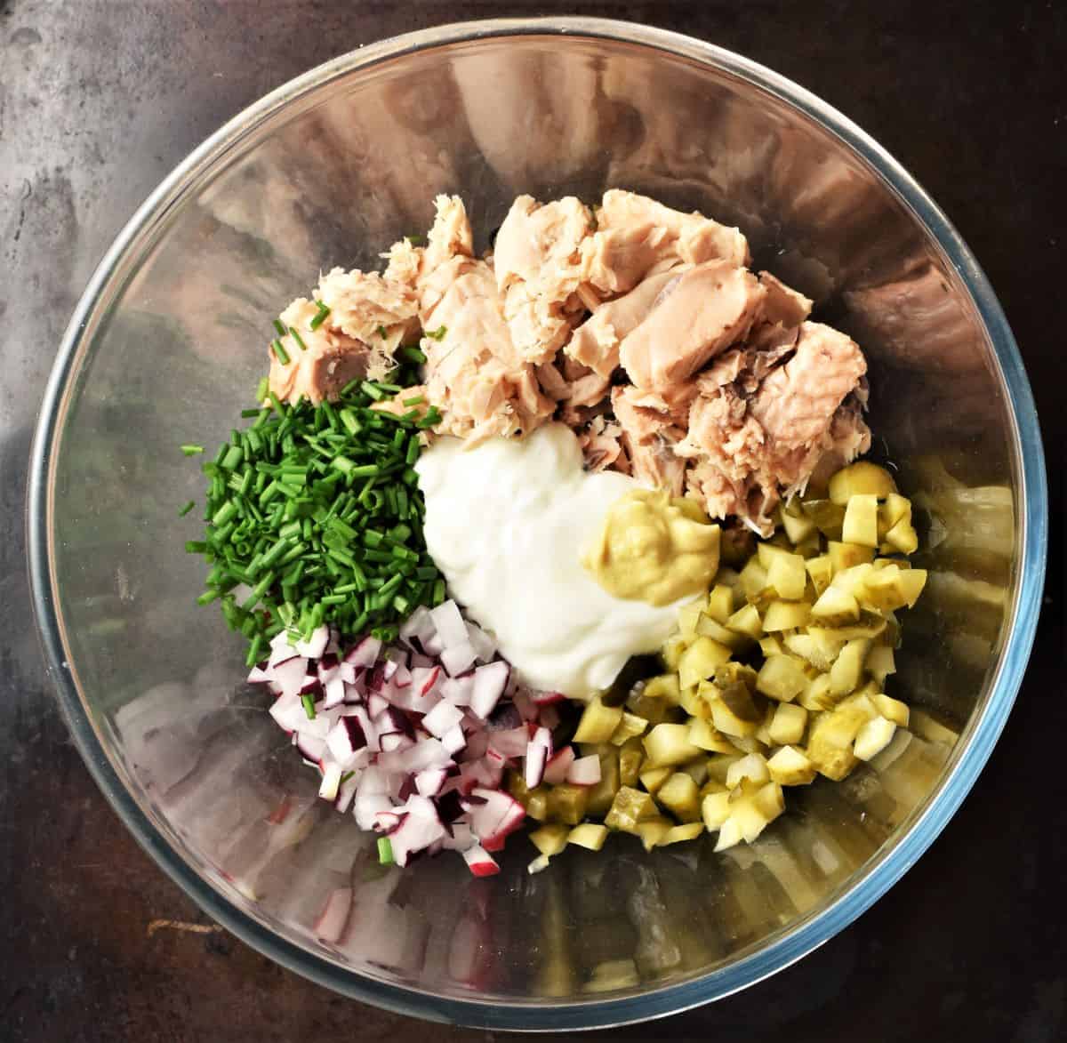 Ingredients for making salmon salad sandwich filling mixture in large bowl.