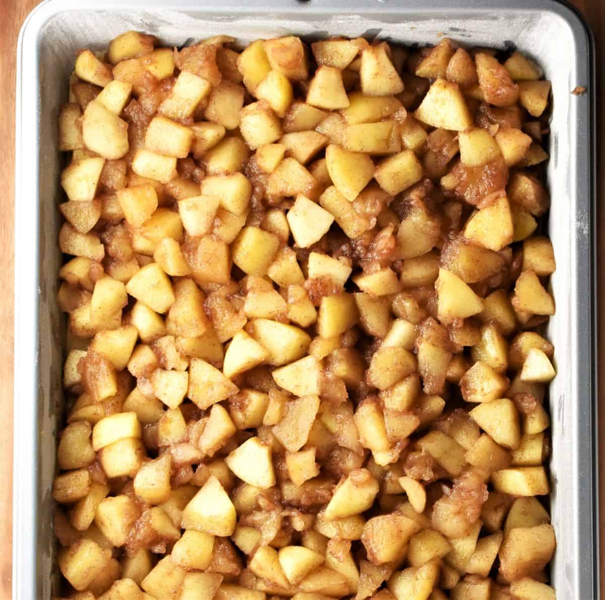 Apple filling for Polish apple cake in rectangular pan.
