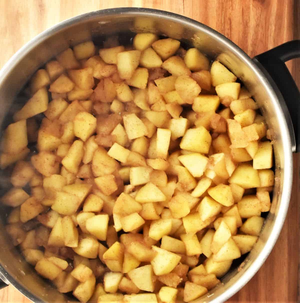 Cooked cubed apples in large pot.
