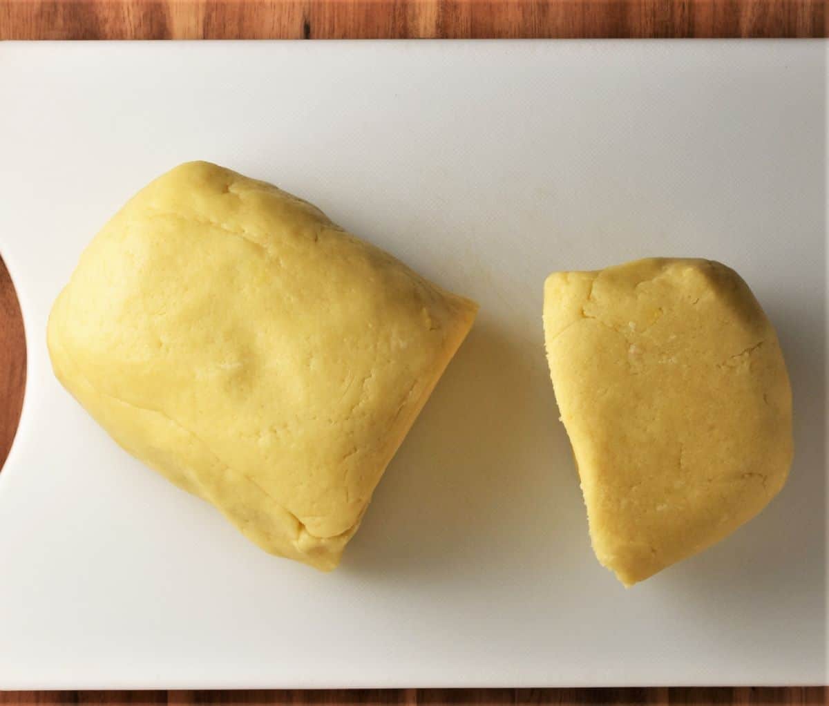 2 pieces of dough on top of white board.