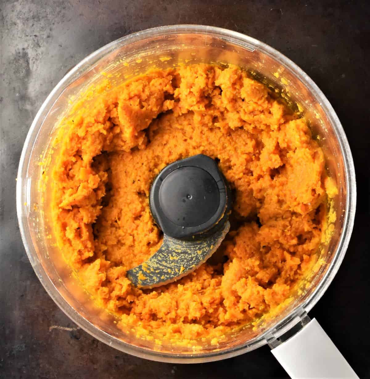 Carrot puree inside food processor bowl.