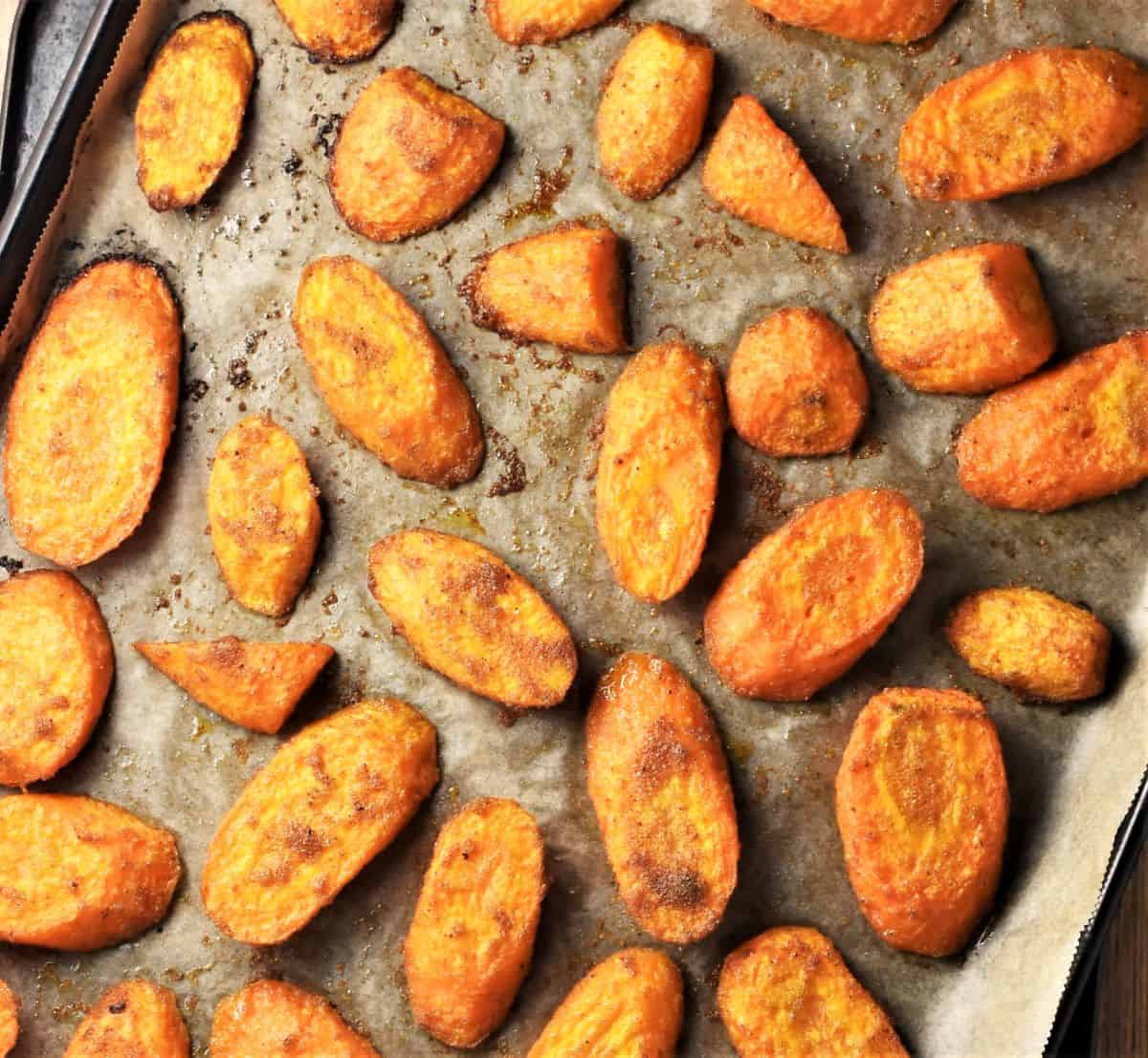 Roasted carrot slices on top of parchment.