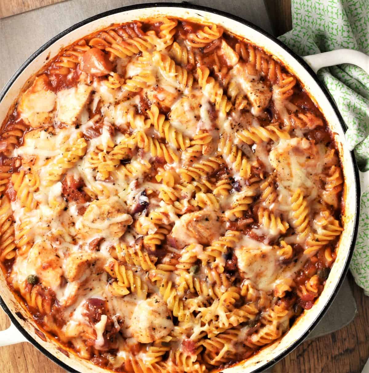 Pasta bake with chicken in large shallow round dish.
