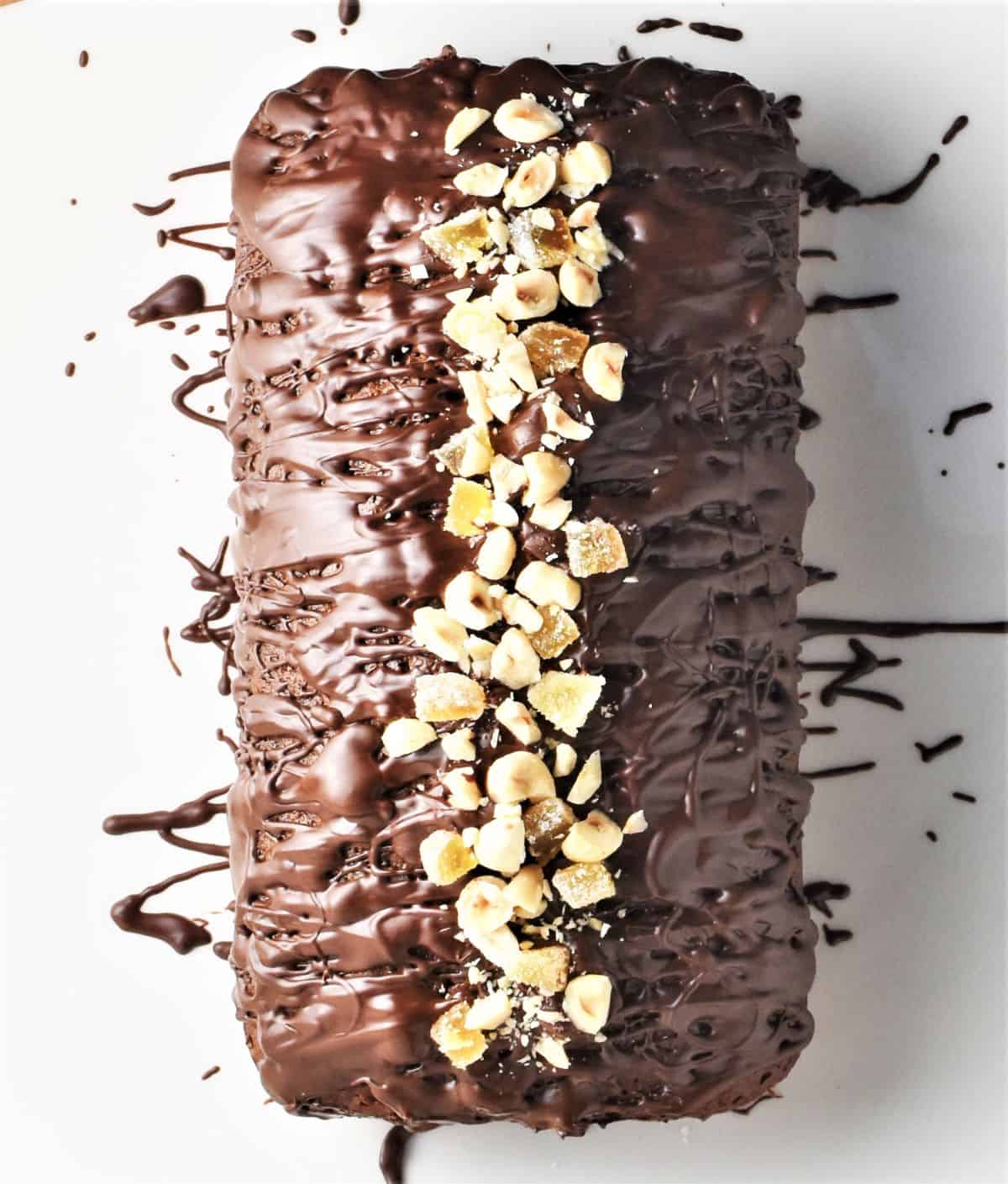 Top down view of gingerbread loaf with chocolate glaze and chopped nuts.