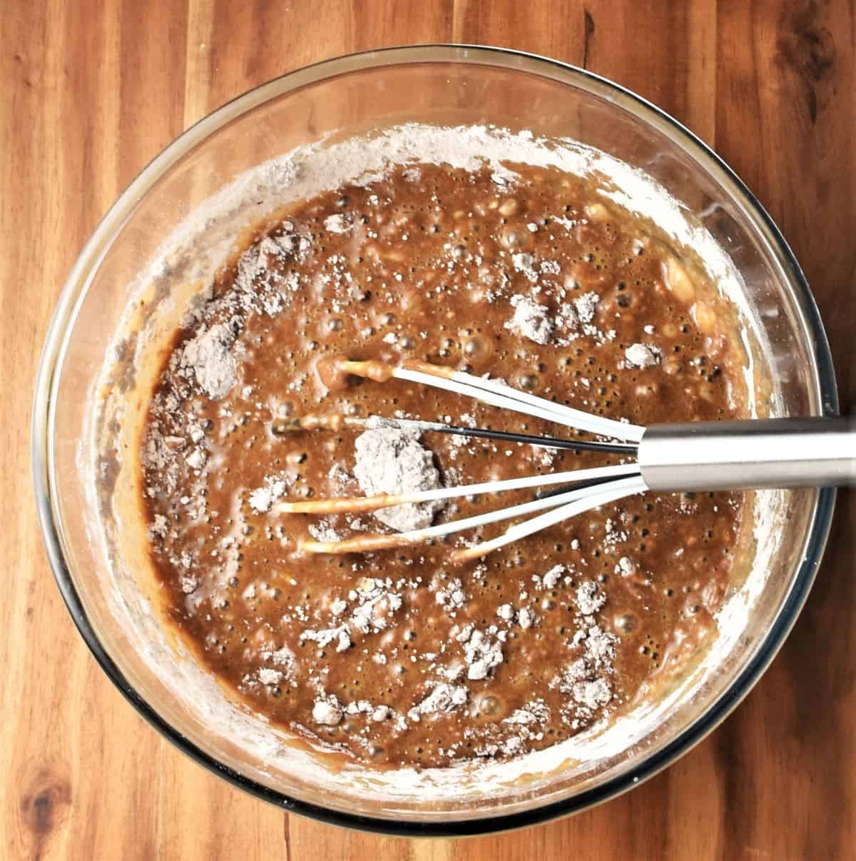 Making gingerbread batter in large bowl with whisk.
