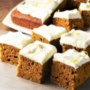 Side view of slices of pumpkin cake with cream cheese frosting.