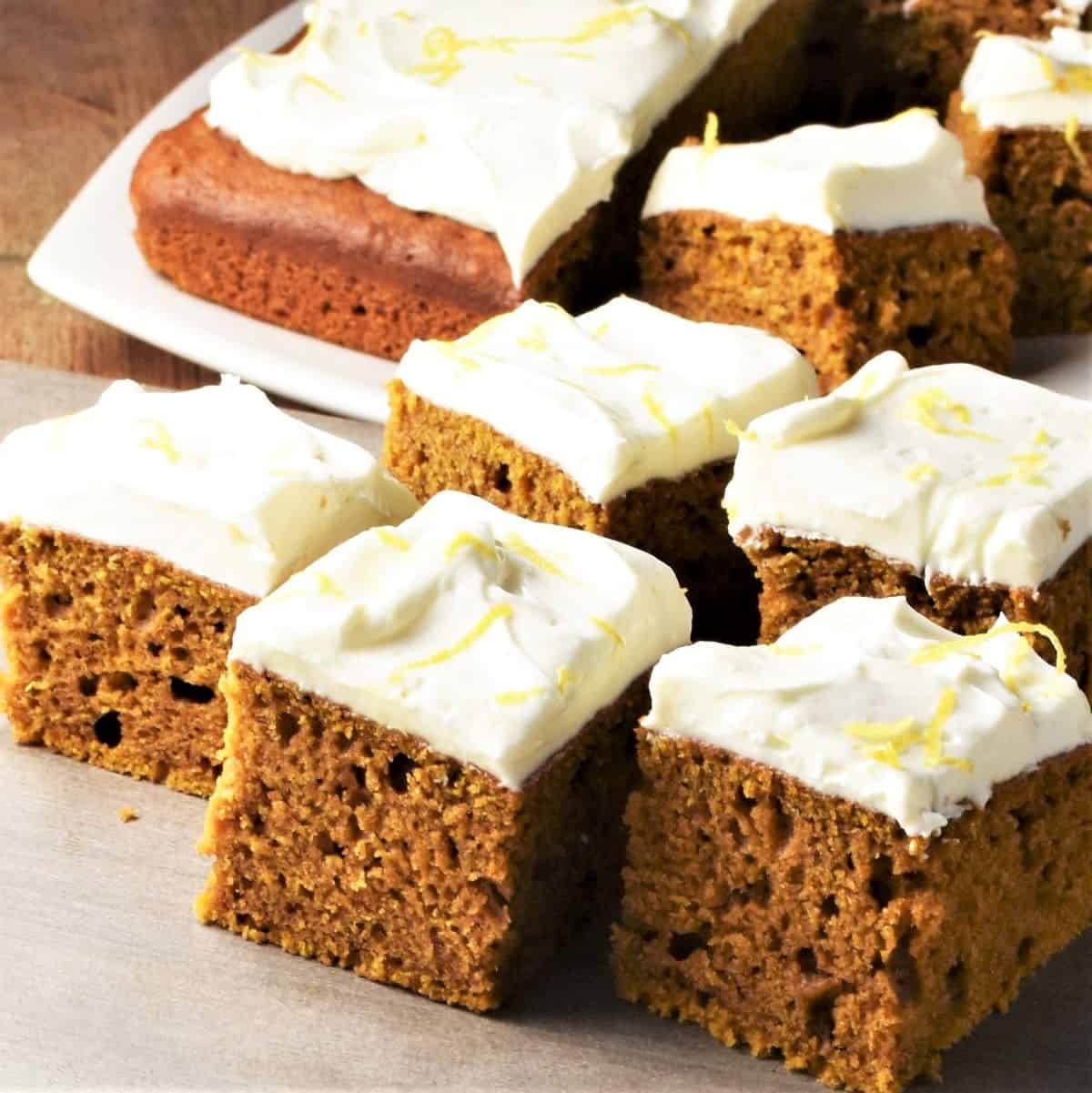 Side view of slices of pumpkin cake with cream cheese frosting.