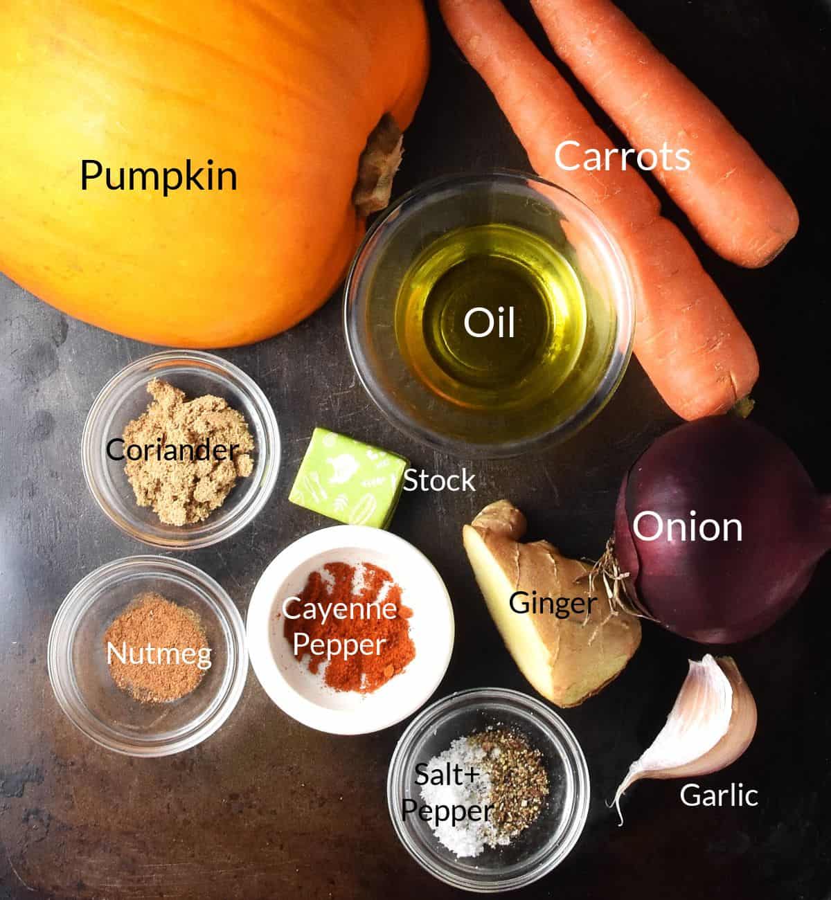 Top down view of ingredients for making carrot pumpkin soup in individual dishes.