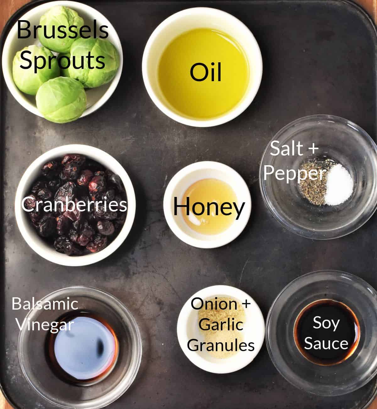 Ingredients for making brussels sprouts with cranberries in individual dishes.