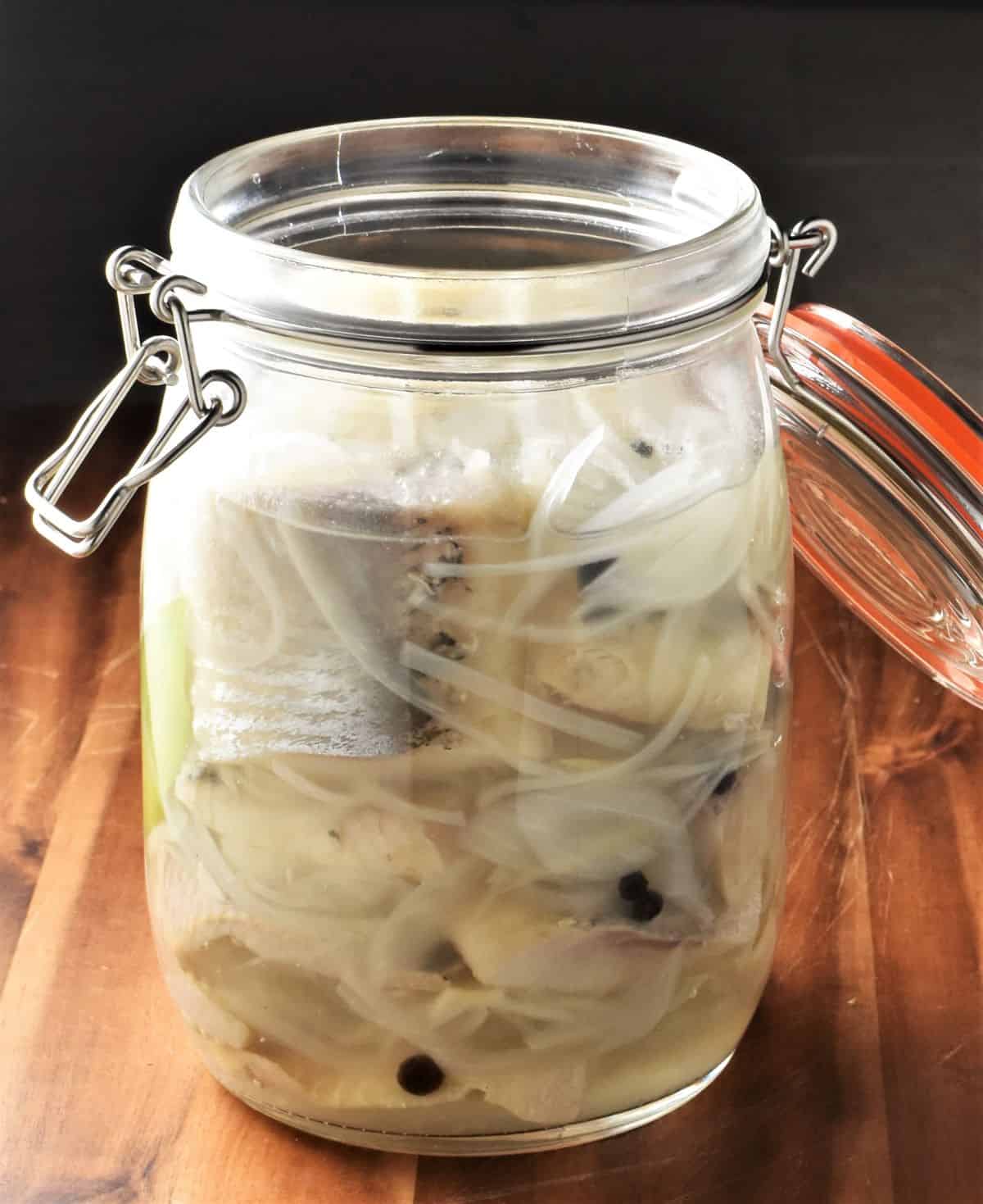Side view of Polish herring in open jar.