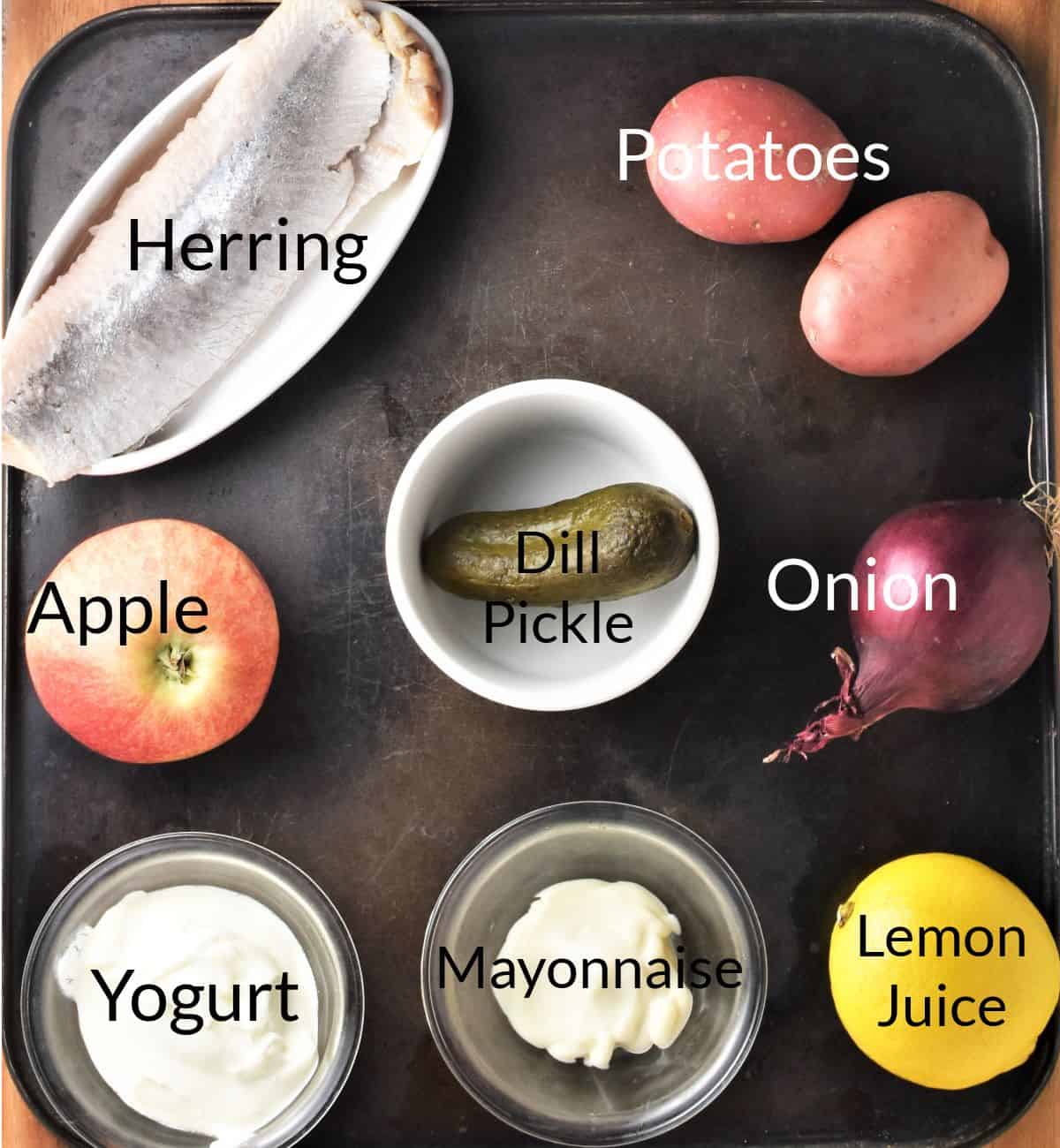Ingredients for making herring salad in individual dishes.