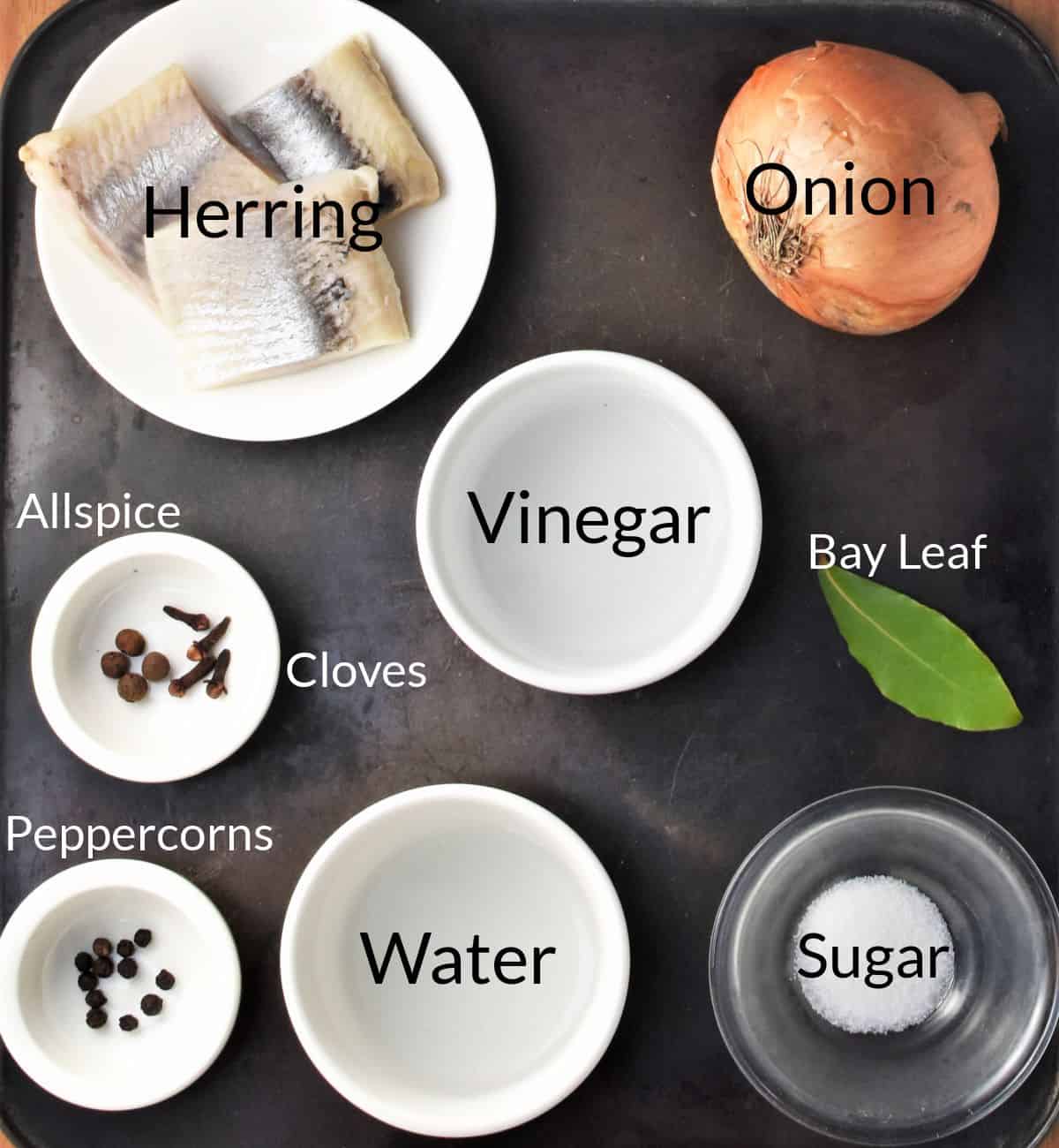 Ingredients for ,making Polish pickled herring in individual dishes.