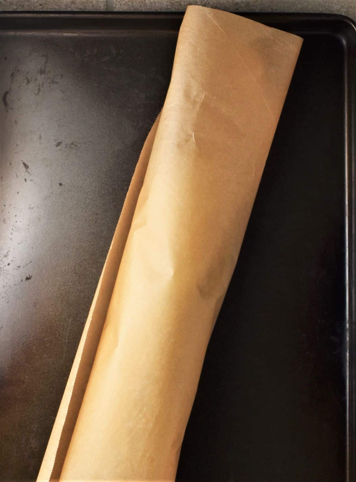 Poppy seed roll cake wrapped in parchment.