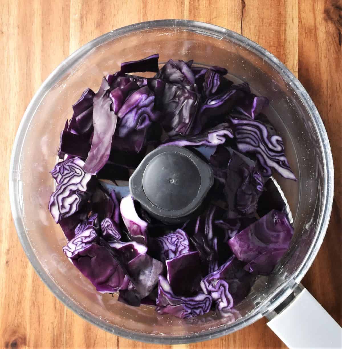 Chopped red cabbage in blender bowl.