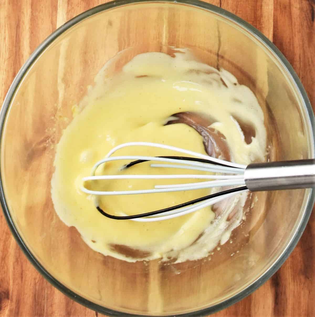 Whisking mayo in large bowl.