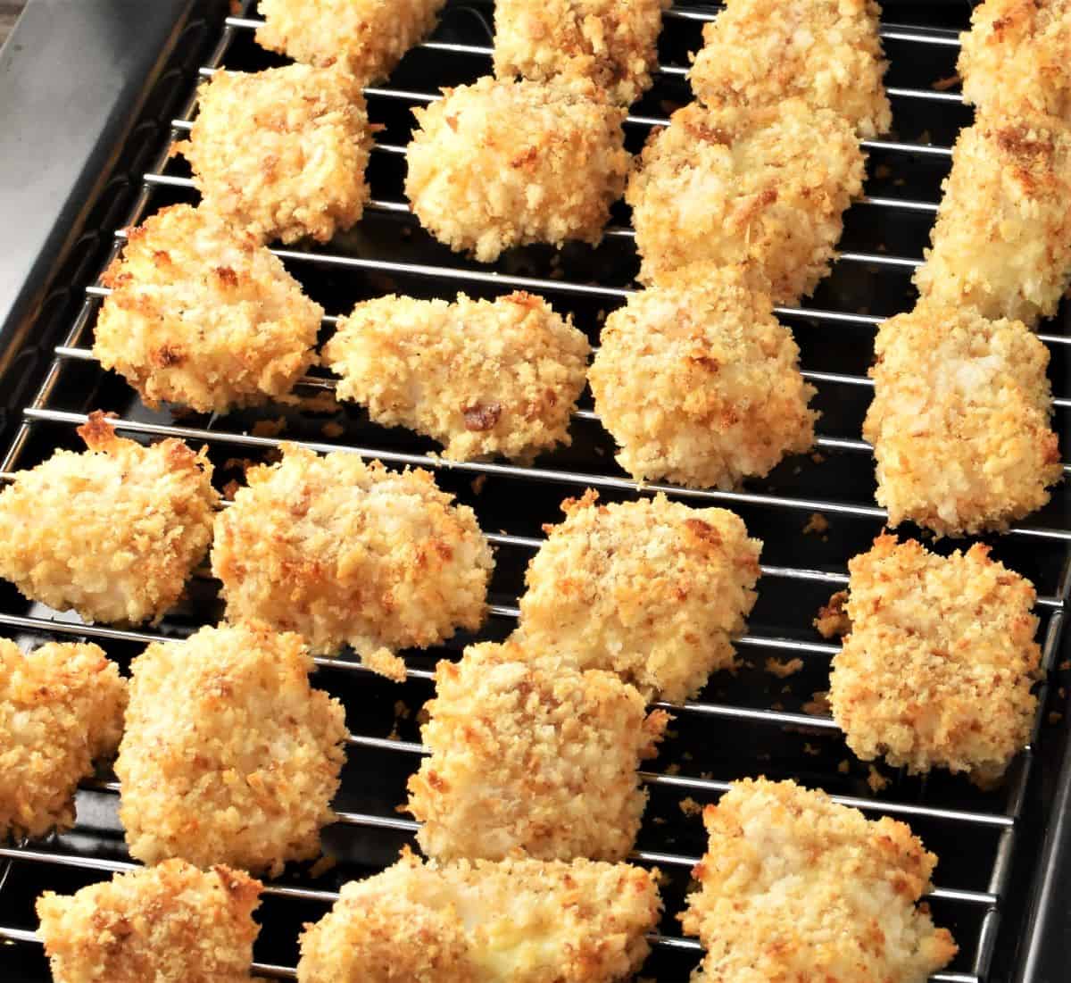 Side view of baked crispy fish nuggets on top of rack.