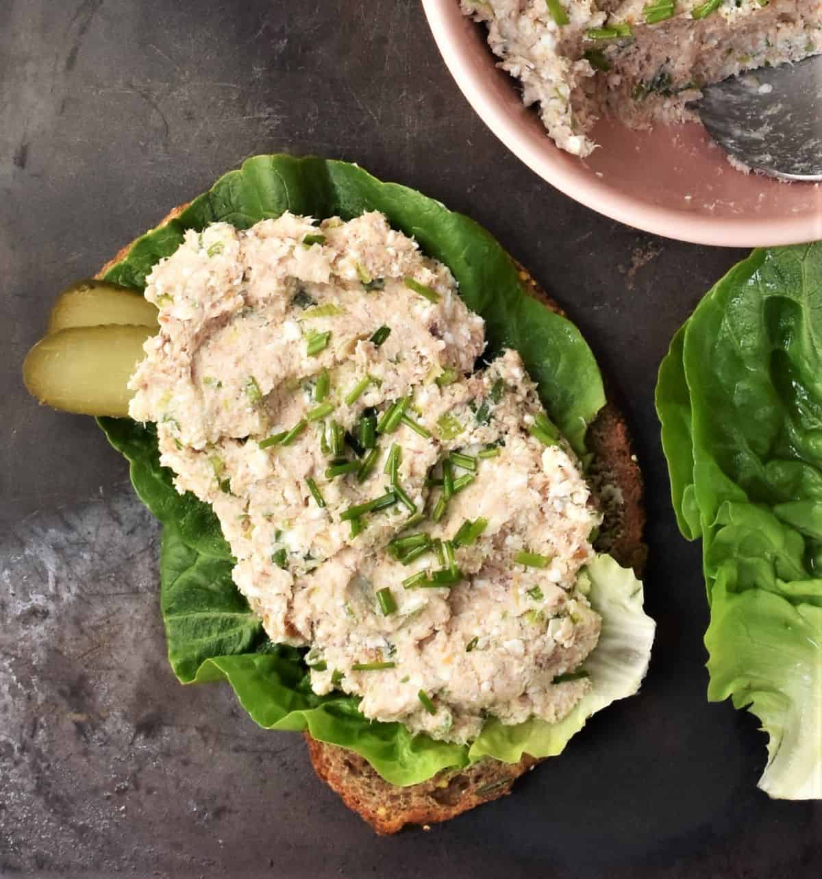 Mackerel pate on top of bread slice with lettuce.