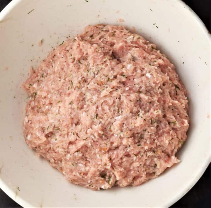 Chicken meatball mixture for soup in white bowl.