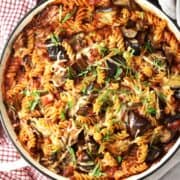 Top down view of eggplant pasta bake in shallow round pan.