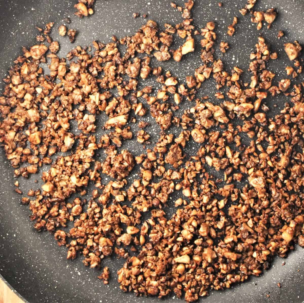 Finely chopped mushrooms in large pan.
