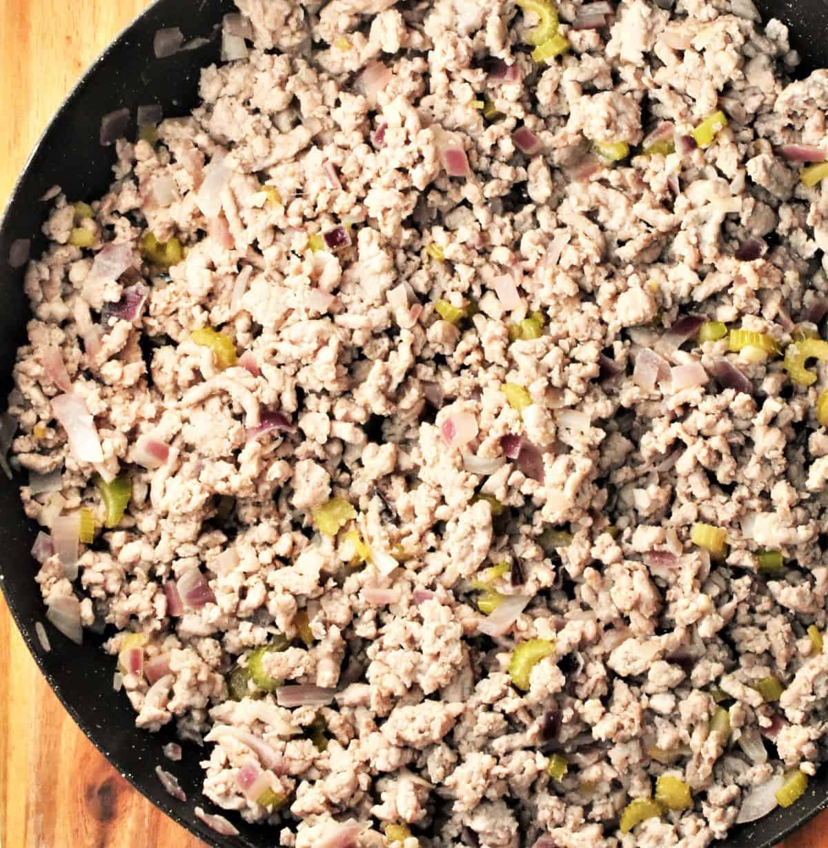 Cooking ground turkey in large pan.