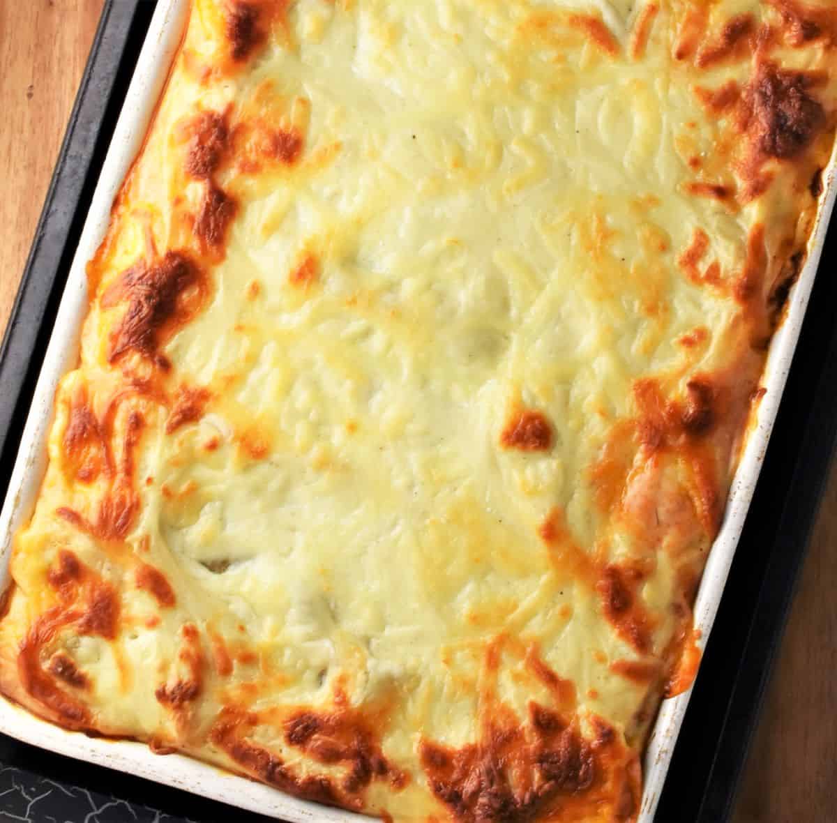Baked lasagna with turkey and creamy sauce browned on top.