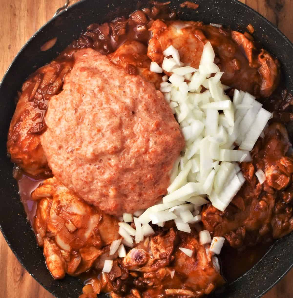 Chicken with paprika, pureed tomato and chopped onion.