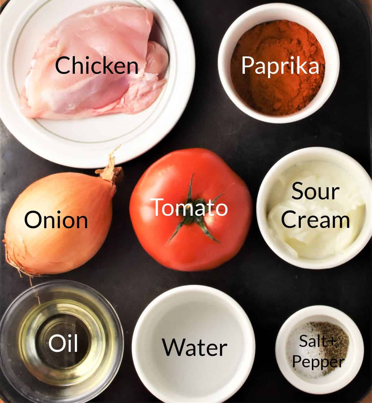 Ingredients for making Hungarian chicken paprikash recipe in individual dishes.