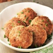 Side view of Polish kotlety in white bowl.