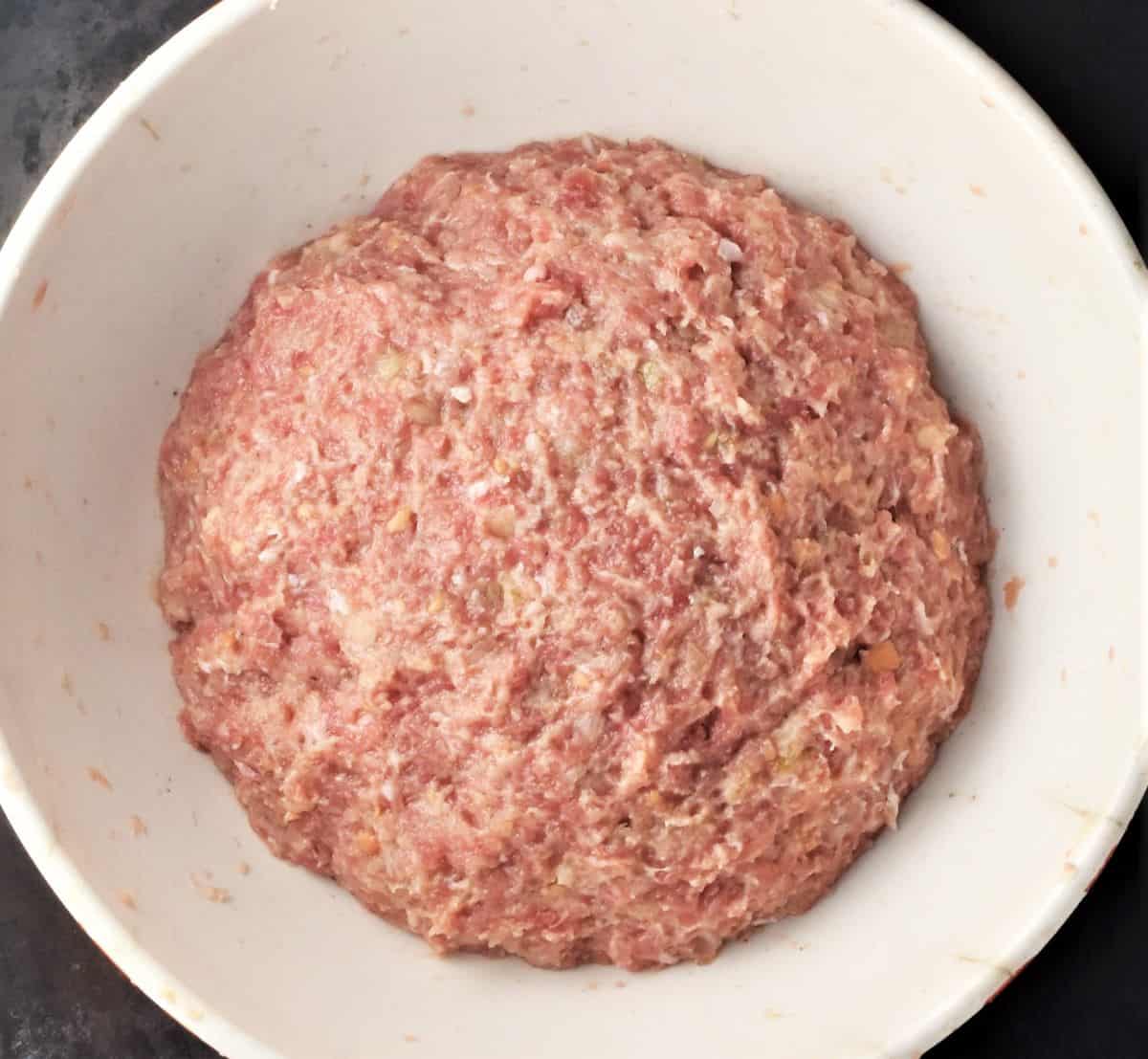 Smooth ground meat kotlety mixture in white bowl.