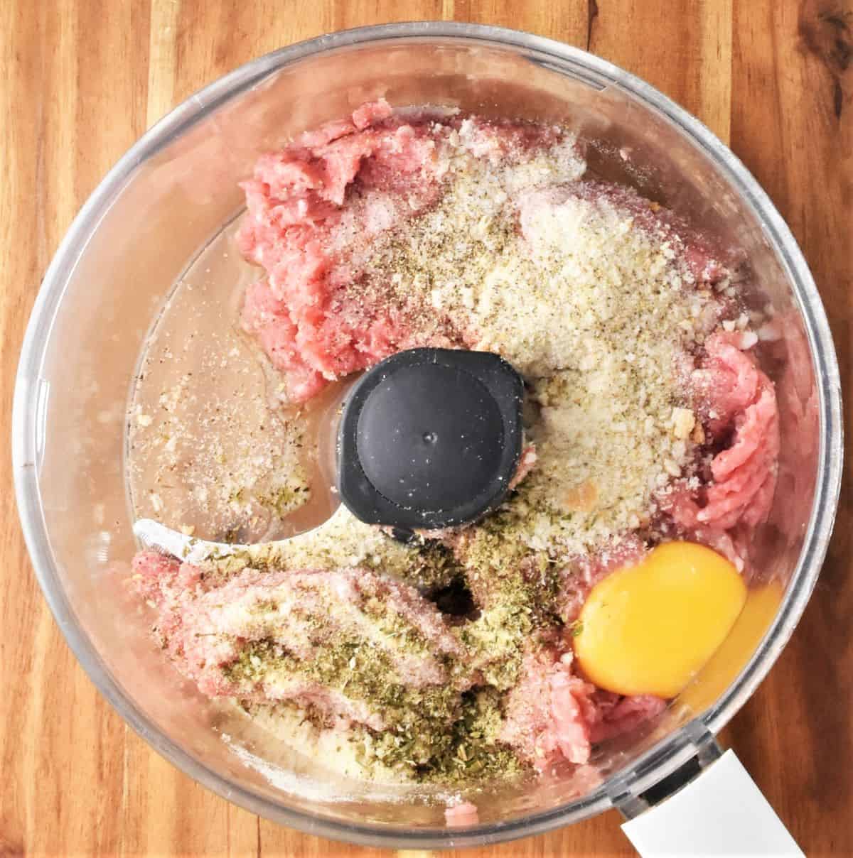 Top down view of meatball ingredients in food processor.